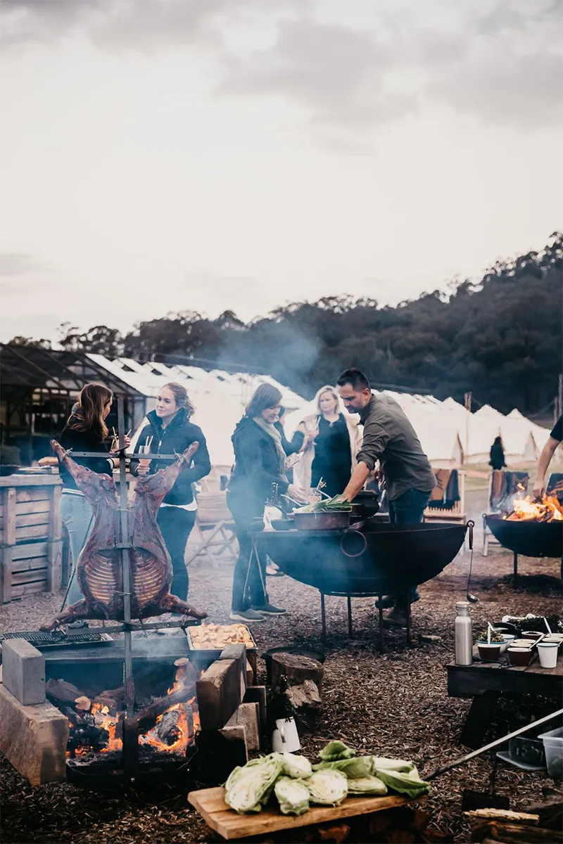 Open-fire cooking over coals at an outdoor event at Stix Farm by PEARL