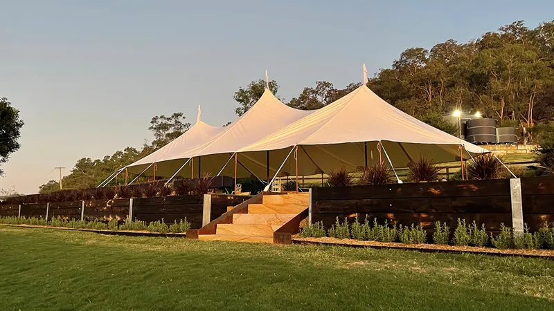 White stretch marquee on a lawn at Stix Farm by PEARL at sunset